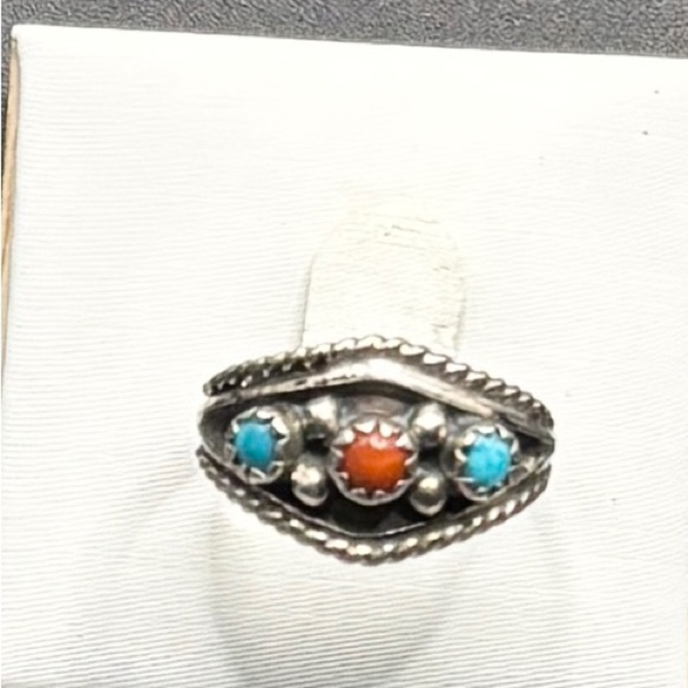 A Sterling Silver Navajo ring with Turquoise and Coral stones